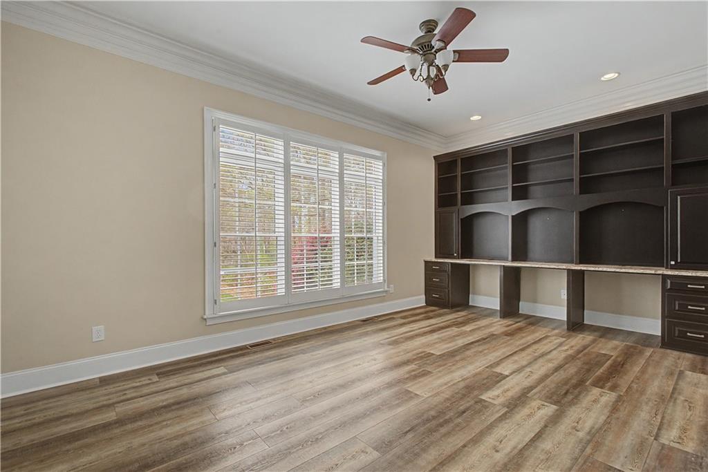 3045 Camp Branch Road Buford, GA 30519 - Photo 27 of 76 a view of empty room with wooden floor and fan