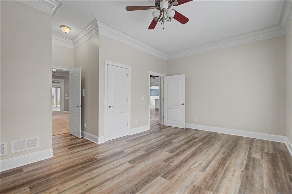 3045 Camp Branch Road Buford, GA 30519 - Photo 29 of 76 a view of a room with wooden floor and ceiling fan