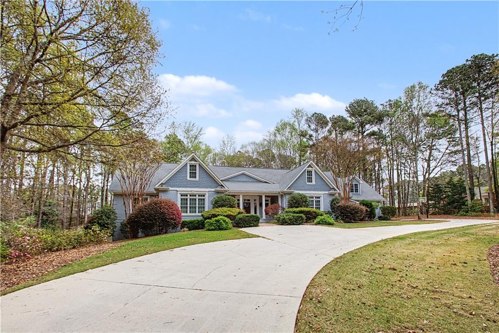 3045 Camp Branch Road Buford, GA 30519 - Photo 3 of 76 a front view of a house with a garden