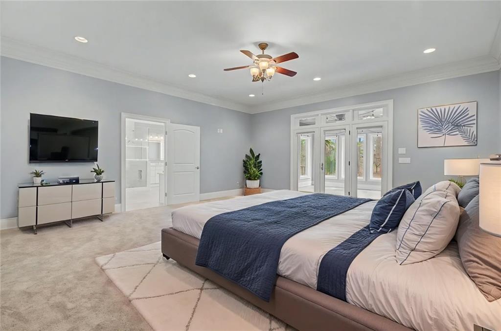 3045 Camp Branch Road Buford, GA 30519 - Photo 31 of 76 a bedroom with a large bed and a flat screen tv