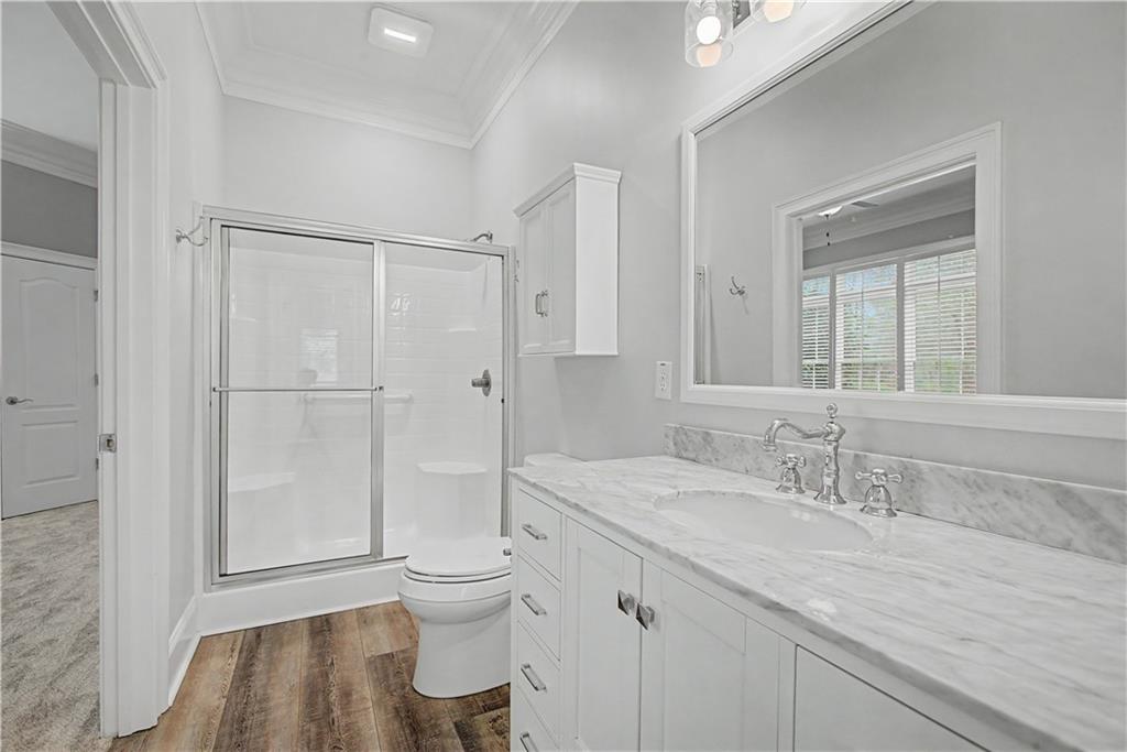3045 Camp Branch Road Buford, GA 30519 - Photo 32 of 76 a bathroom with a granite countertop sink toilet and shower