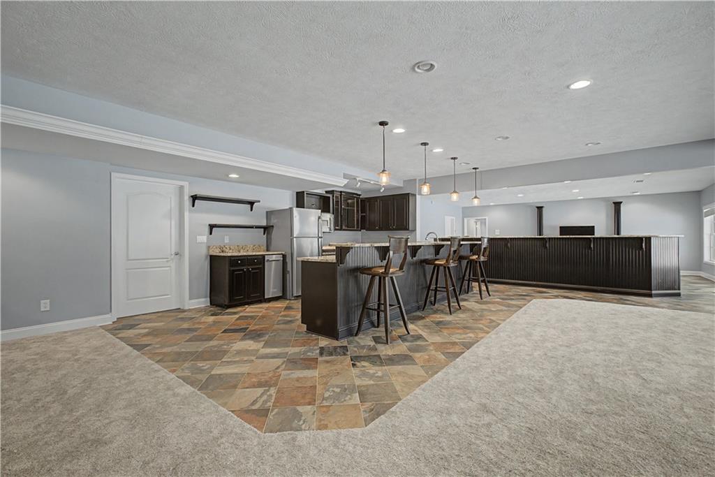 3045 Camp Branch Road Buford, GA 30519 - Photo 49 of 76 a large kitchen with a table and chairs