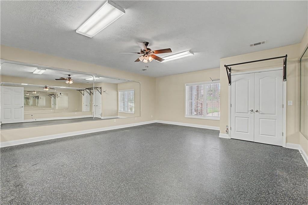 3045 Camp Branch Road Buford, GA 30519 - Photo 54 of 76 a view of an empty room with chandelier fan and wooden floor