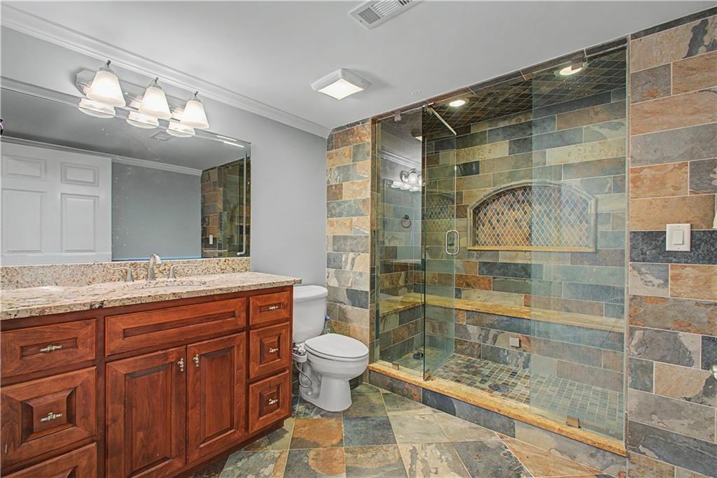 3045 Camp Branch Road Buford, GA 30519 - Photo 55 of 76 a bathroom with a granite countertop sink toilet and shower