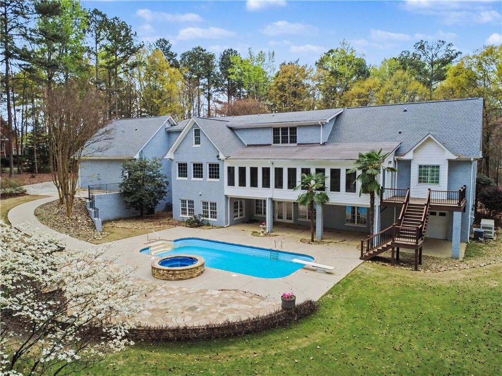3045 Camp Branch Road Buford, GA 30519 - Photo 60 of 76 an aerial view of a house roof deck with chairs and wooden fence