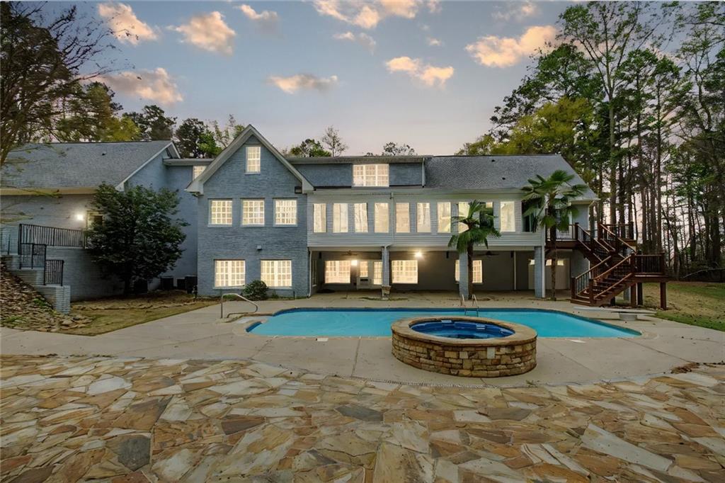 3045 Camp Branch Road Buford, GA 30519 - Photo 75 of 76 a view of a white house with a swimming pool and porch