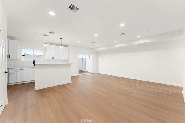 a view of kitchen with wooden floor and window