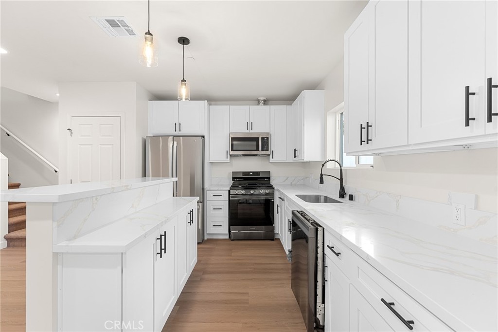 902 South Hert Street Colton, CA 92324 - Photo 13 of 34 a kitchen with cabinets stainless steel appliances and a counter space