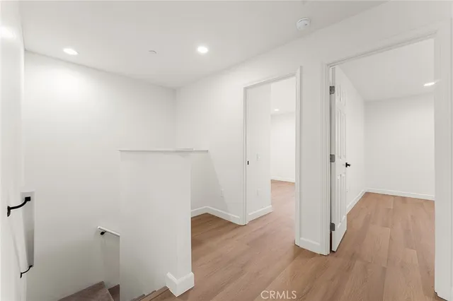 a view of a room with wooden floor and window