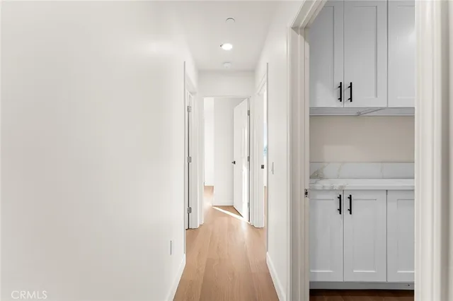 a utility room with cabinets washer and dryer