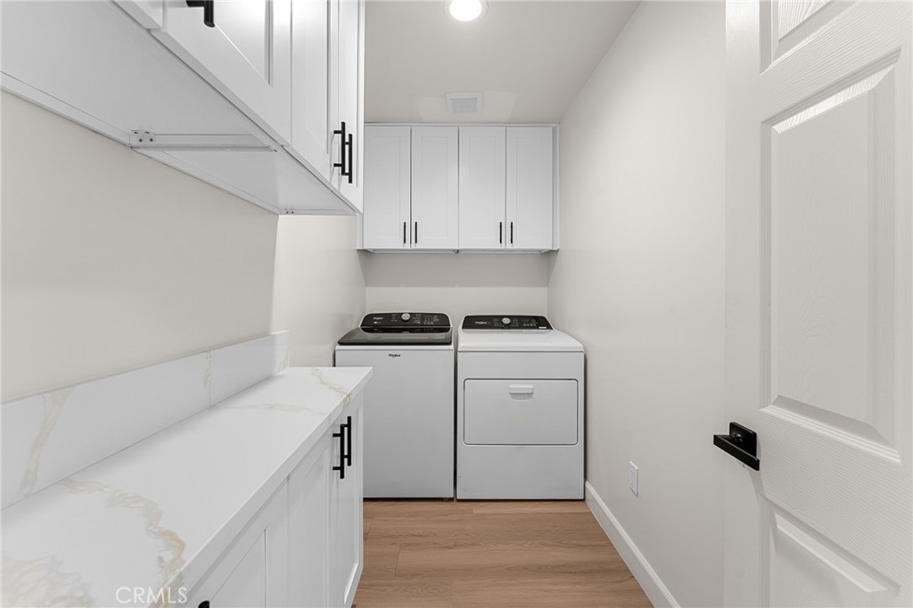 902 South Hert Street Colton, CA 92324 - Photo 28 of 34 a utility room with cabinets washer and dryer