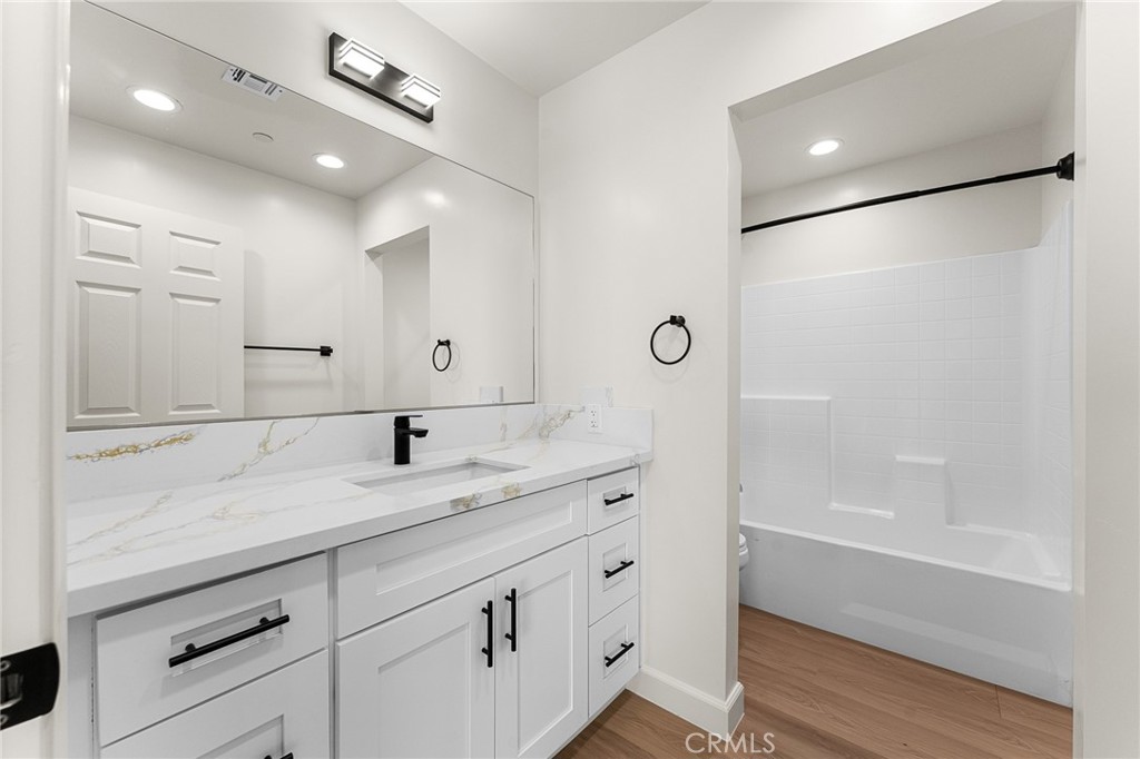902 South Hert Street Colton, CA 92324 - Photo 29 of 34 a bathroom with a granite countertop sink mirror and a shower