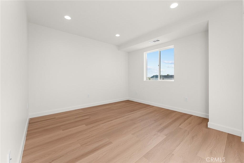 902 South Hert Street Colton, CA 92324 - Photo 31 of 34 an empty room with wooden floor and windows