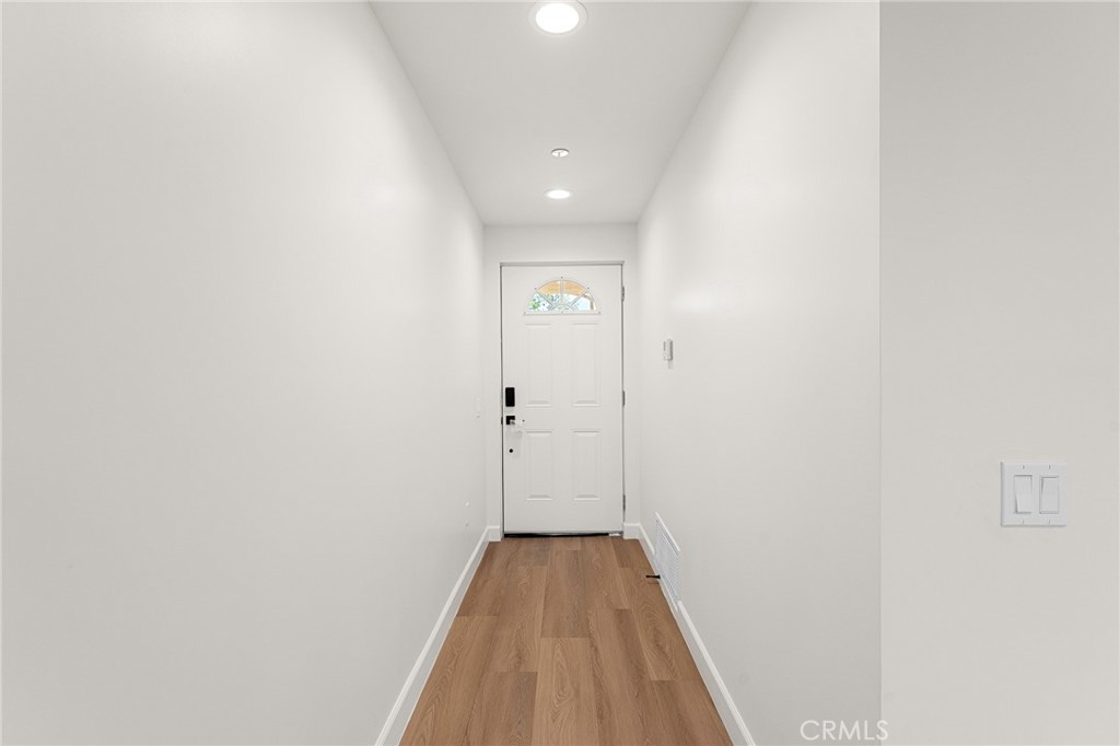 902 South Hert Street Colton, CA 92324 - Photo 7 of 34 a view of a hallway with wooden floor and a bathroom