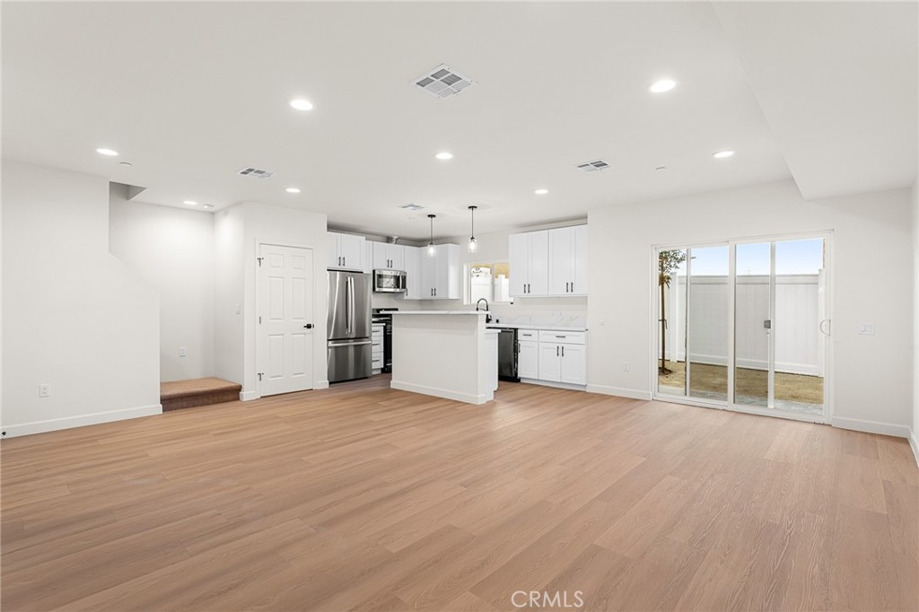 902 South Hert Street Colton, CA 92324 - Photo 8 of 34 an empty room with wooden floor and windows