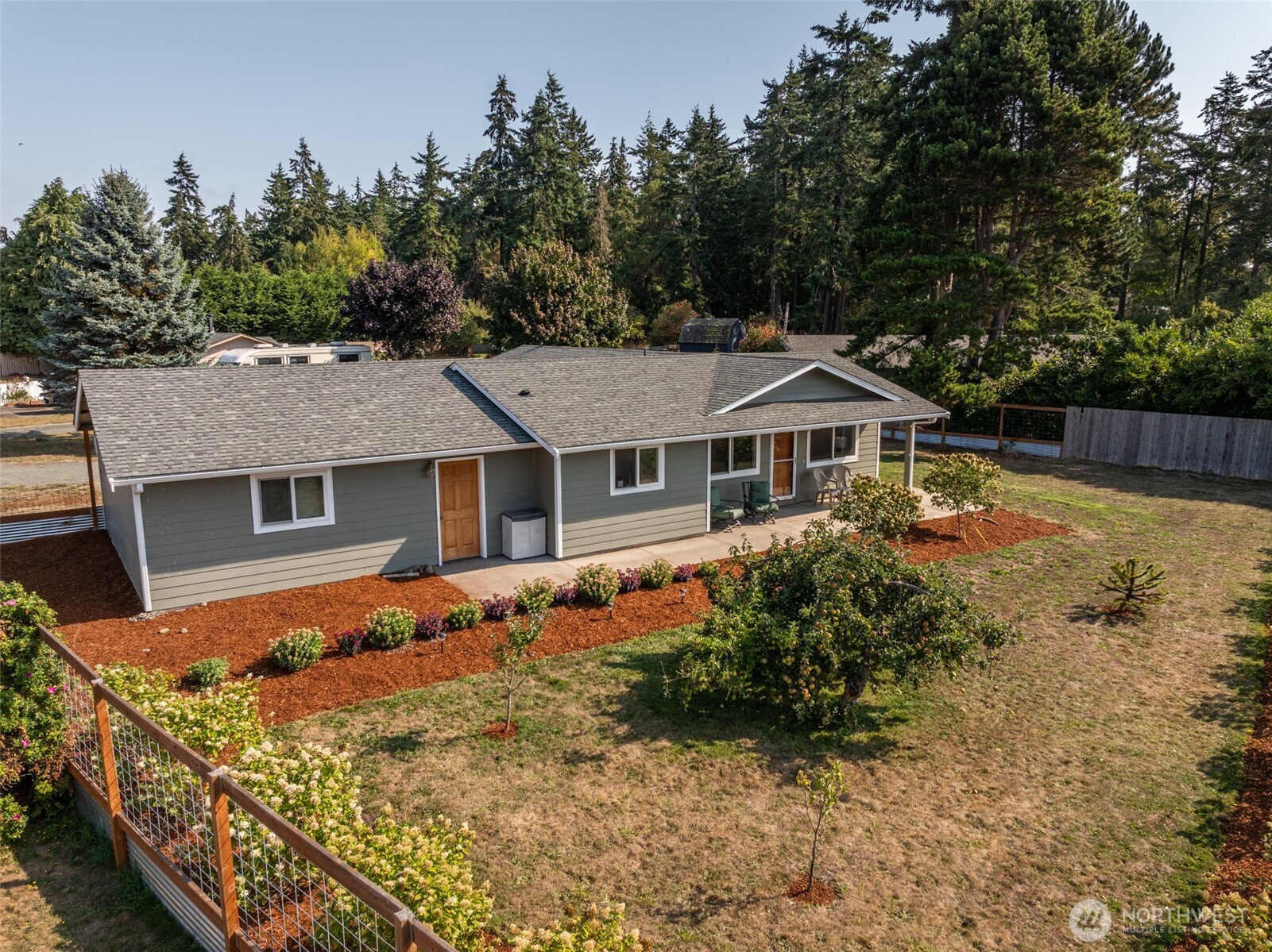 60 Ridge Place Sequim, WA 98382 - Photo 3 of 40 a front view of house with yard and trees in the background