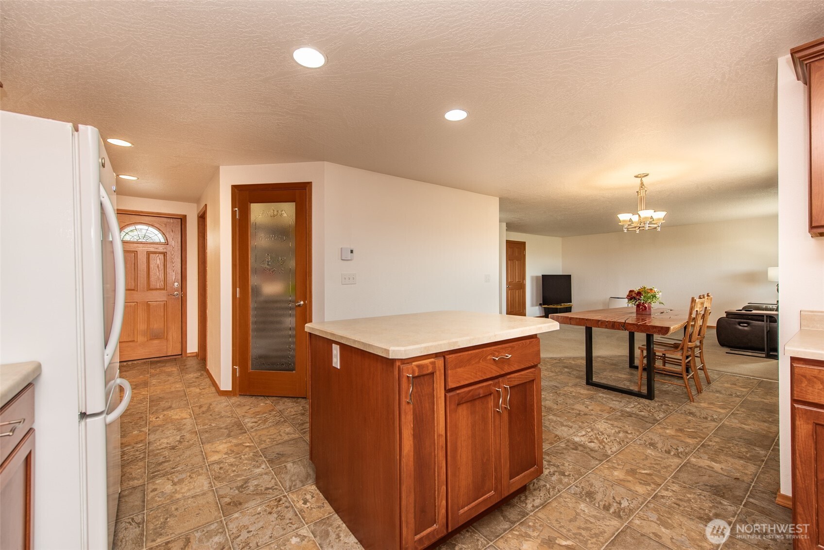 60 Ridge Place Sequim, WA 98382 - Photo 5 of 40 a kitchen with a stove a refrigerator and a dining table