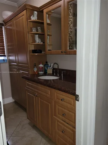 a kitchen with a refrigerator and white cabinets