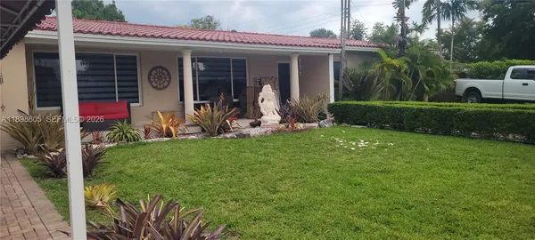 a backyard of a house with lots of green space and trees