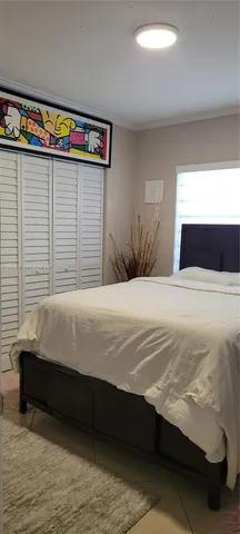 a bedroom with a bed and a window