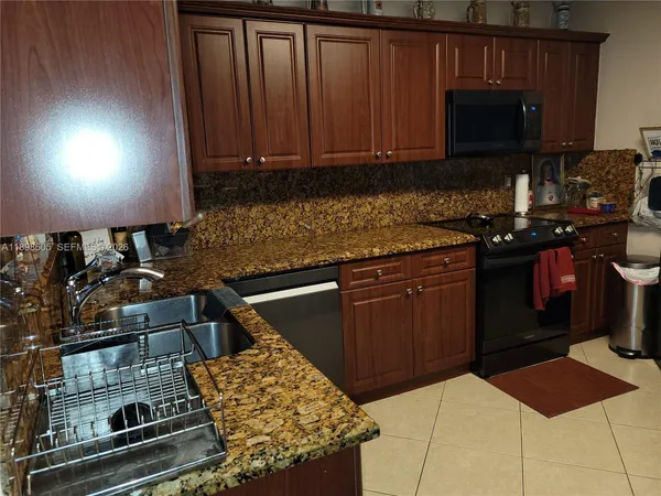 a kitchen with a refrigerator and cabinets