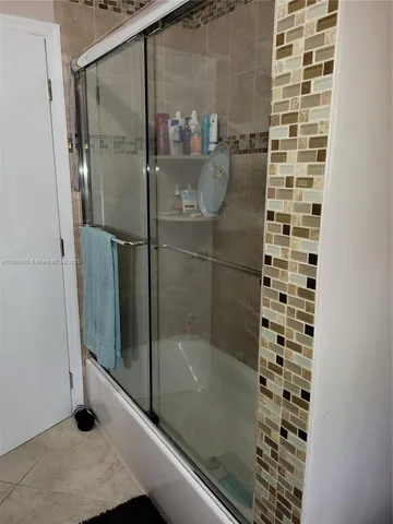 a kitchen with a refrigerator and cabinets