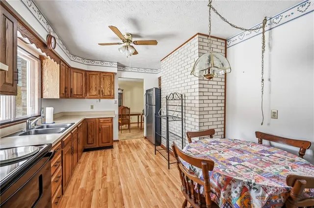 a spacious bedroom with a bed and a dresser next to a window