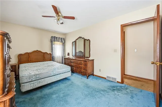 a bedroom with a large bed and a dresser
