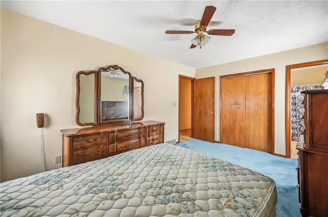 a bedroom with a bed and a dresser in it