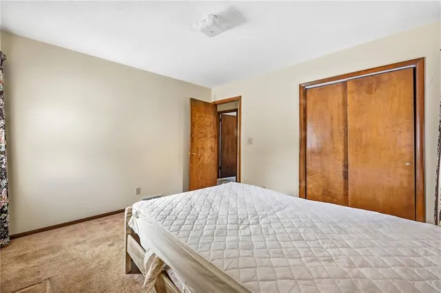 a bedroom with a bed and a dresser