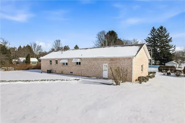 a view of a house with snow on the road