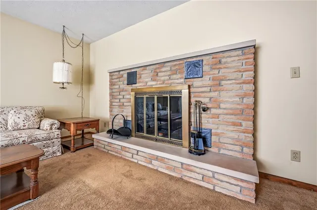 a living room with furniture a window and a fireplace