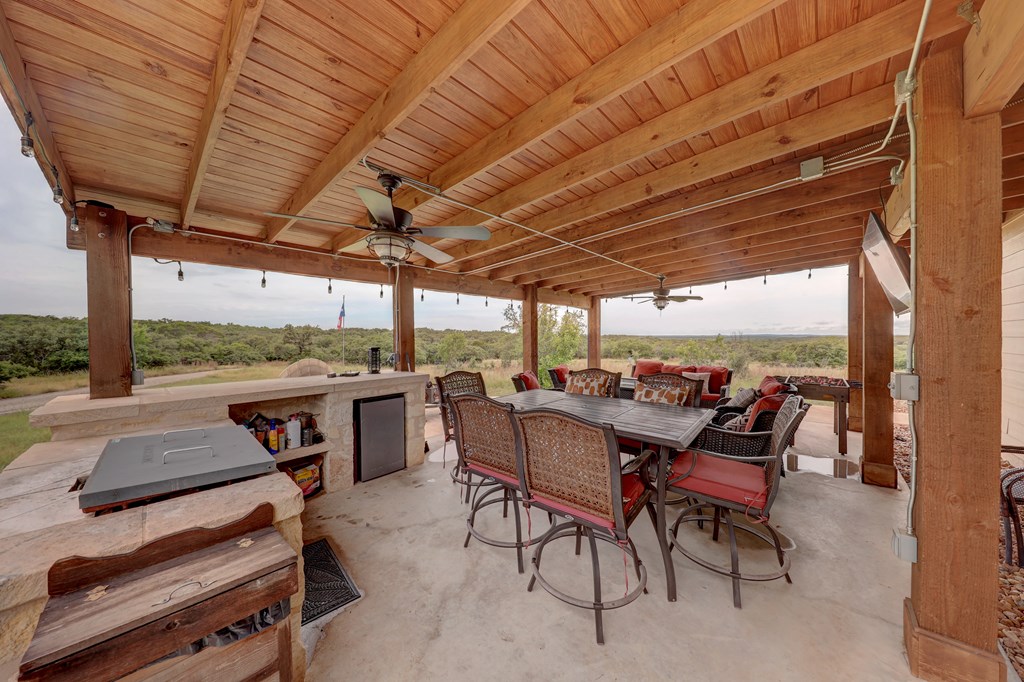 8177 Wendel Road Harper, TX 78631 - Photo 19 of 32 a view of a patio with a table chairs and a grill