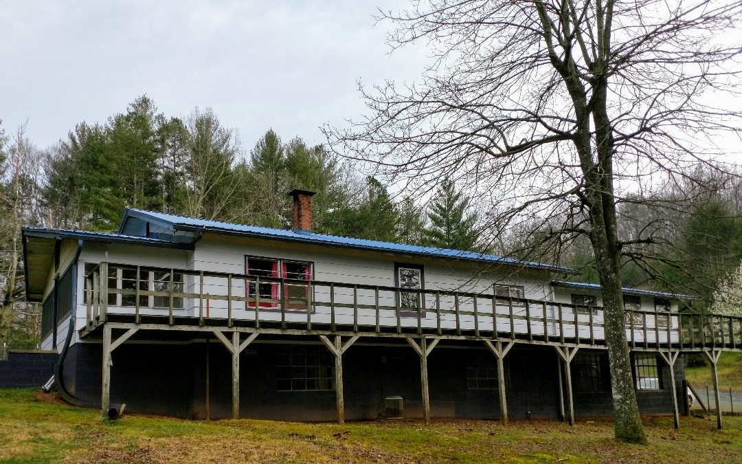 171 Salvage Road Blue Ridge, GA 30513 - Photo 1 of 1 a backyard of a house with large trees