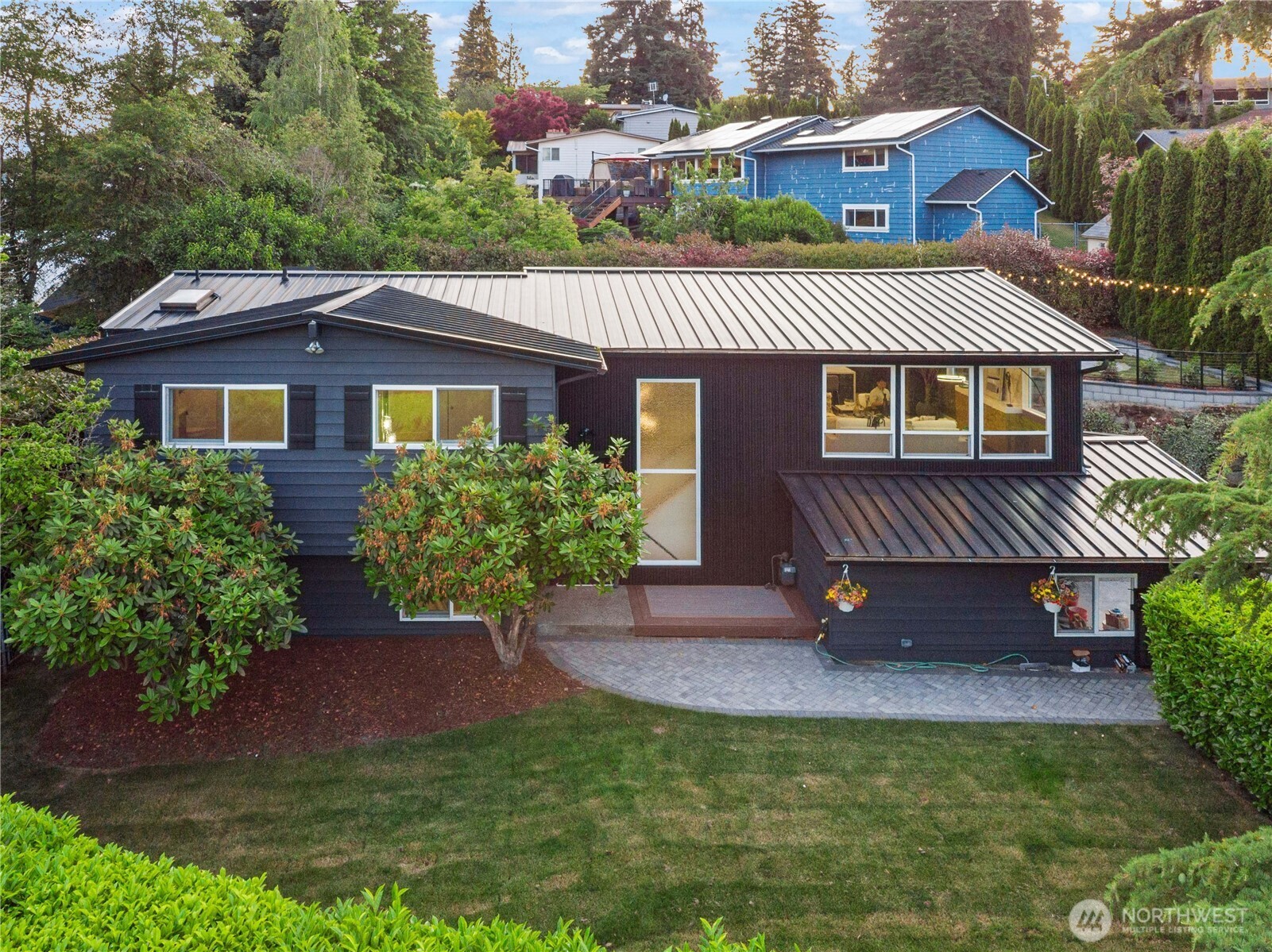 2539 128th Avenue Southeast Bellevue, WA 98005 - Photo 2 of 39 a view of a house with a yard potted plants and a table and chair