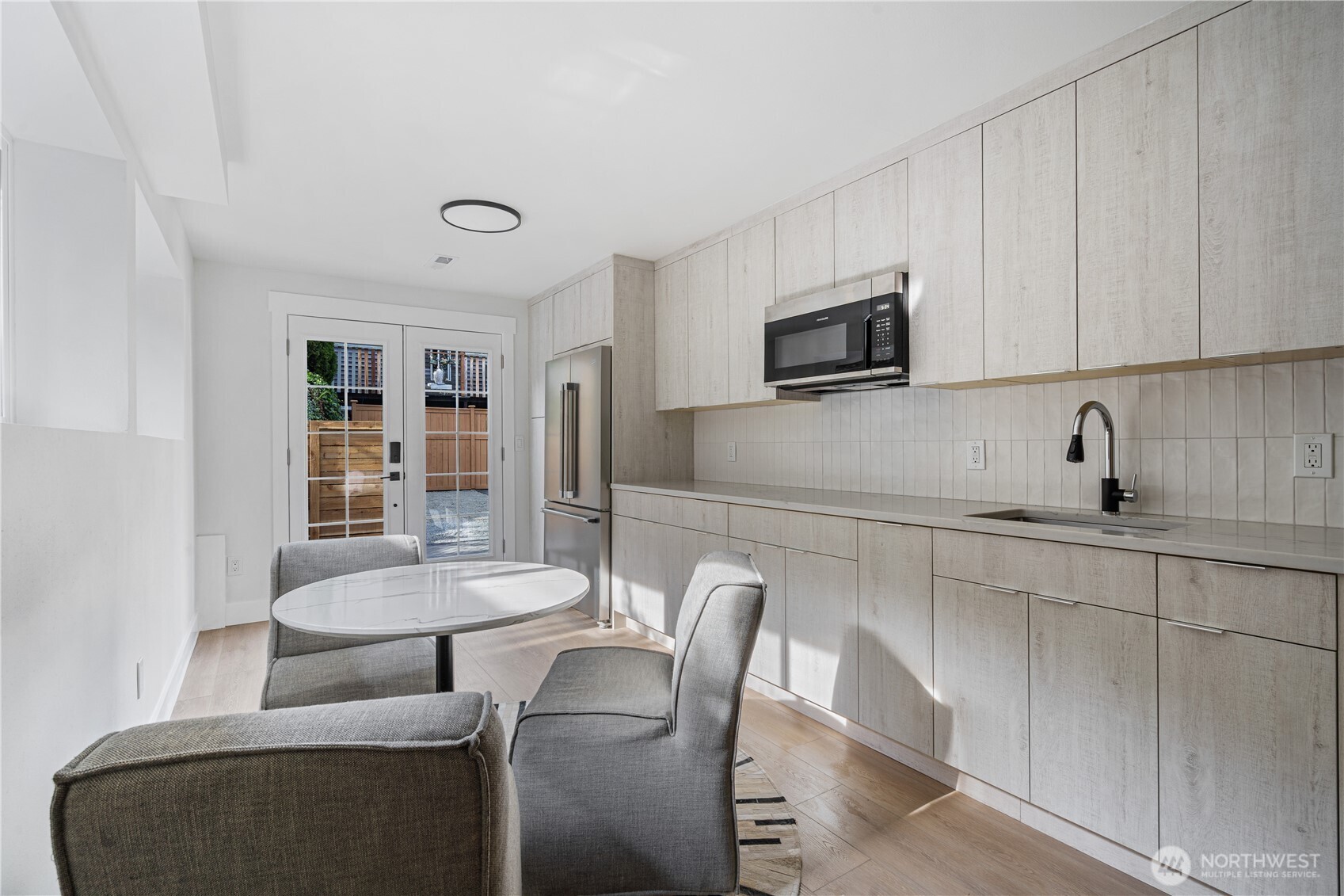 2539 128th Avenue Southeast Bellevue, WA 98005 - Photo 23 of 39 a kitchen with stainless steel appliances dining table and chairs