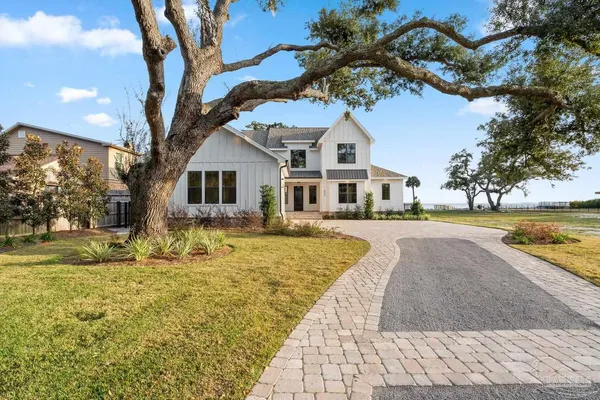 a front view of a house with swimming pool and porch