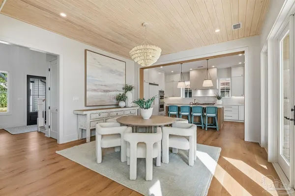 a large kitchen with kitchen island a large island a sink stainless steel appliances and cabinets