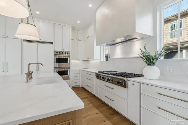 a bathroom with a double vanity sink mirror and bathtub