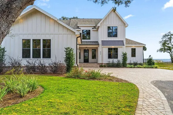 a front view of a house with a yard and porch