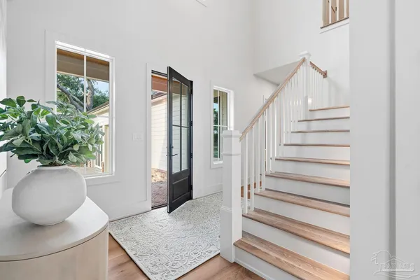 a view of entryway with wooden floor and stairs
