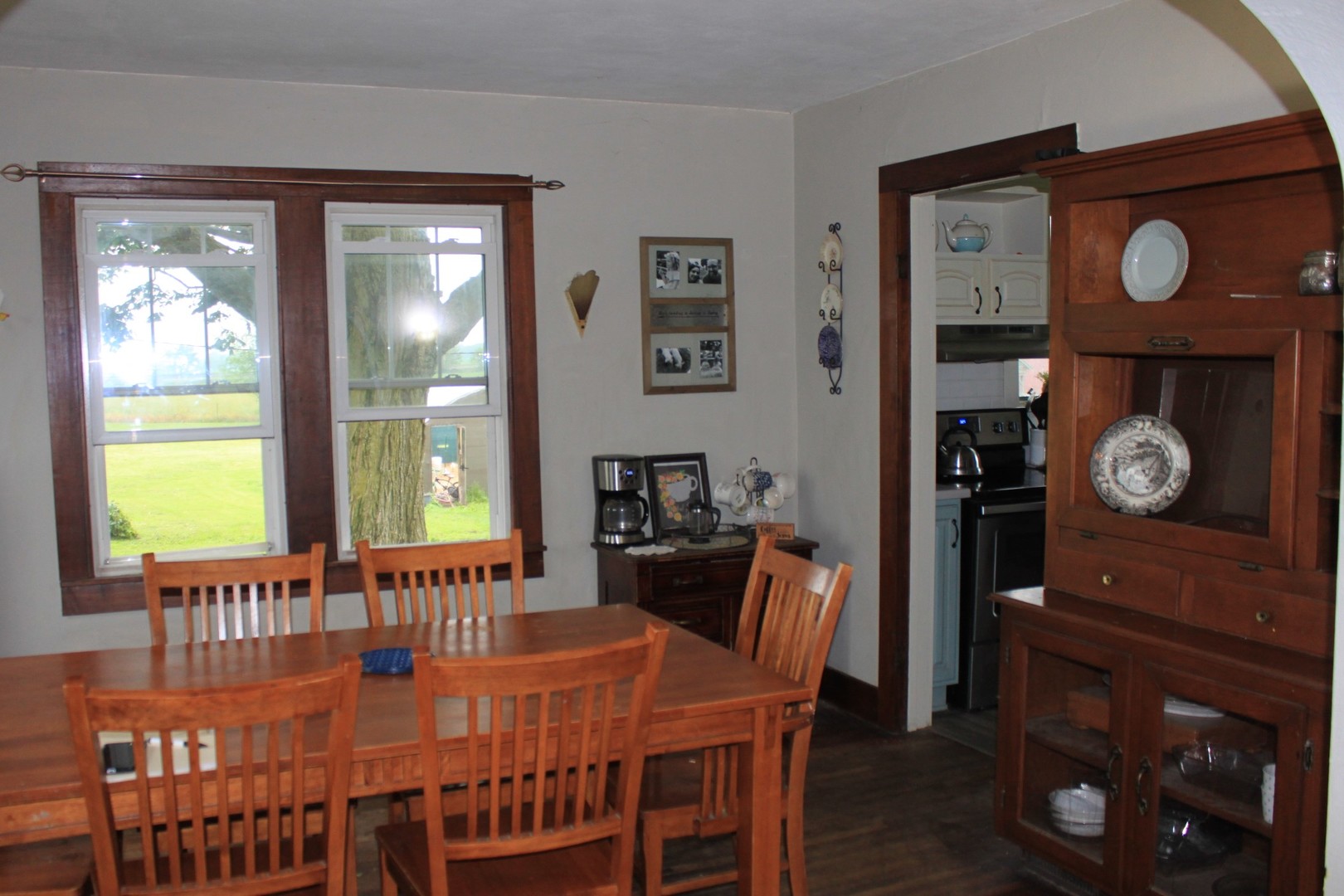 26585 Clark Road Sterling, IL 61081 - Photo 3 of 14 a dining room with a wooden table a lamp and a large window
