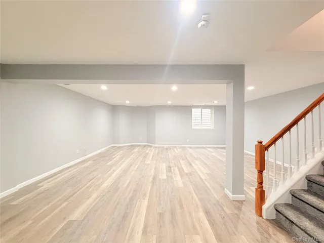 a view of an empty room and wooden floor