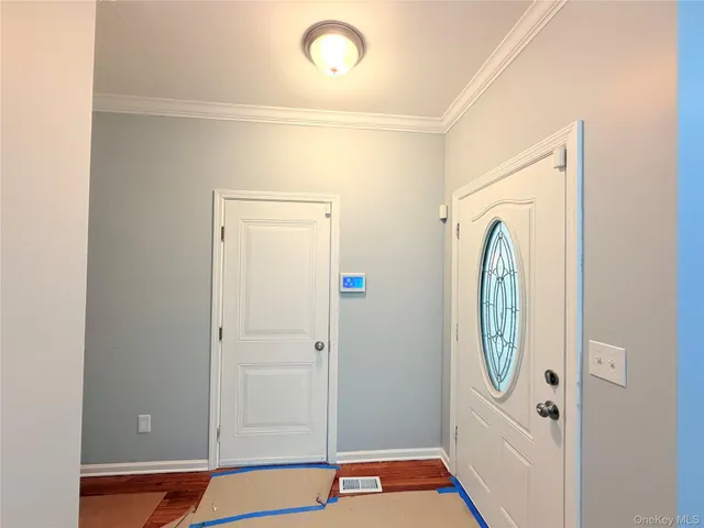 a view of a room with wooden floor and white walls