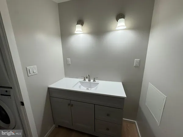 a bathroom with a sink vanity and mirror