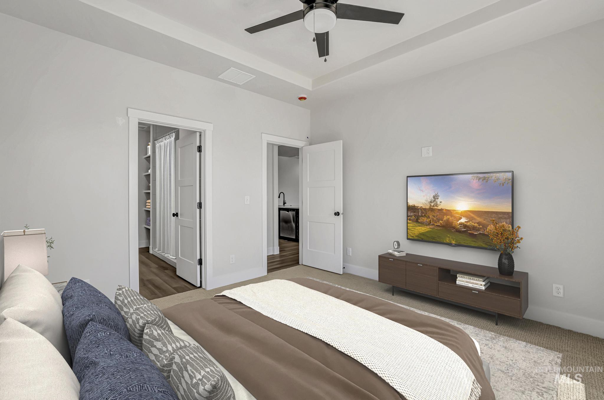 941 Gregory Way Twin Falls, ID 83301 - Photo 17 of 40 Bedroom featuring a ceiling fan and a raised ceiling