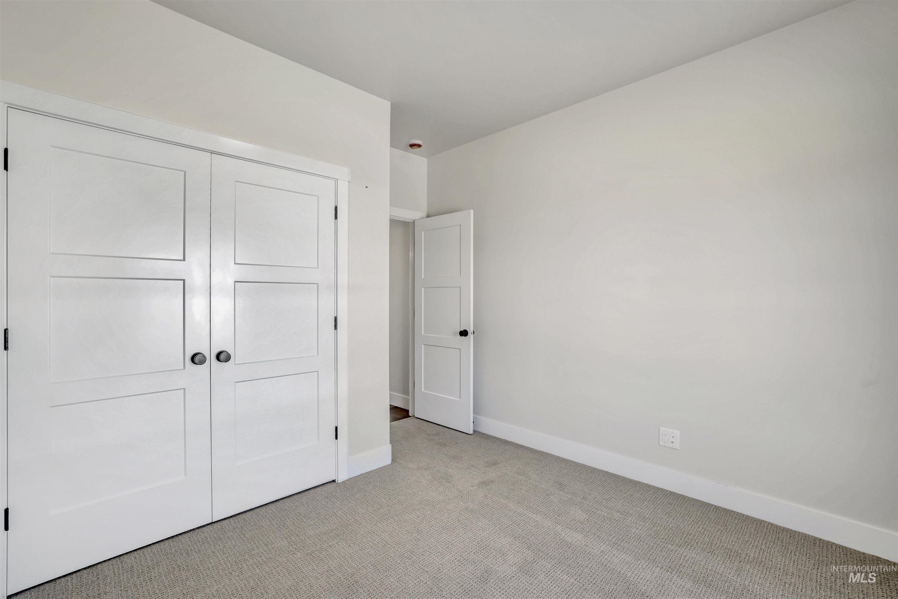 941 Gregory Way Twin Falls, ID 83301 - Photo 26 of 40 Unfurnished bedroom featuring light carpet and a closet