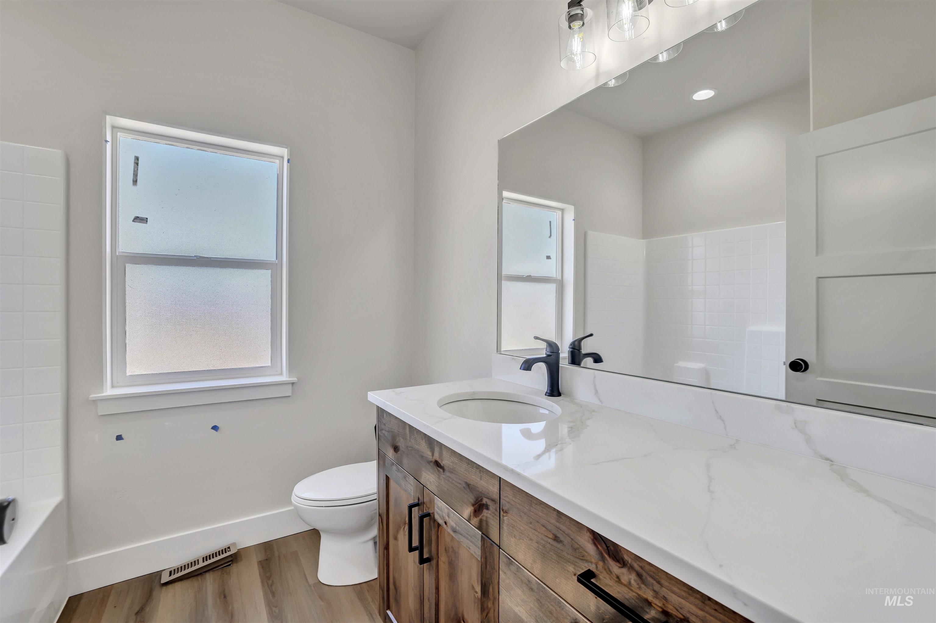 941 Gregory Way Twin Falls, ID 83301 - Photo 29 of 40 Full bathroom featuring vanity and wood finished floors