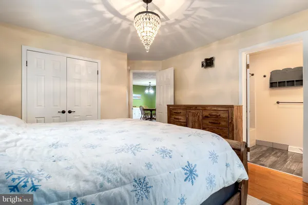a spacious bedroom with a bed and a chandelier