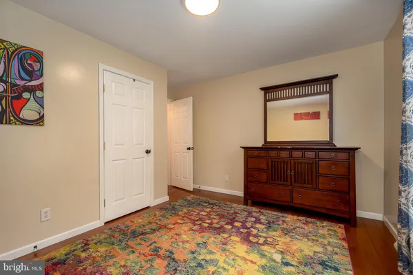 a room with a dresser and a window